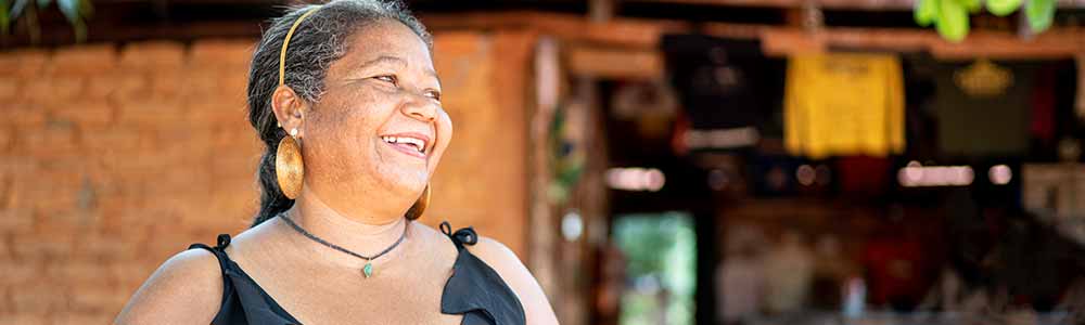 An older Hispanic woman with a big smile on her face