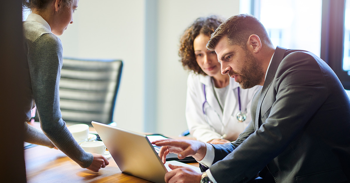 executive reviewing with doctor data on laptop