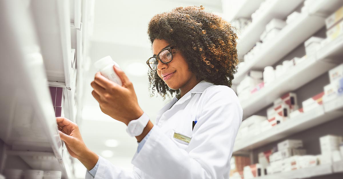 Female pharmacist filling prescriptions