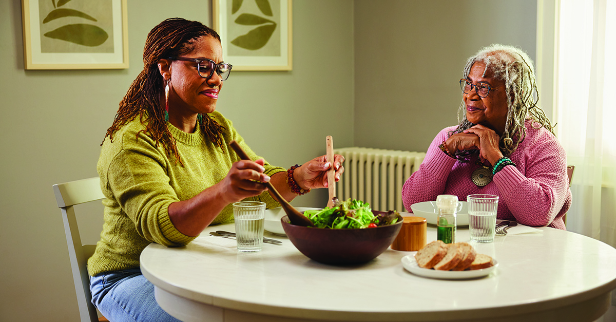 Two women eating at dinner table