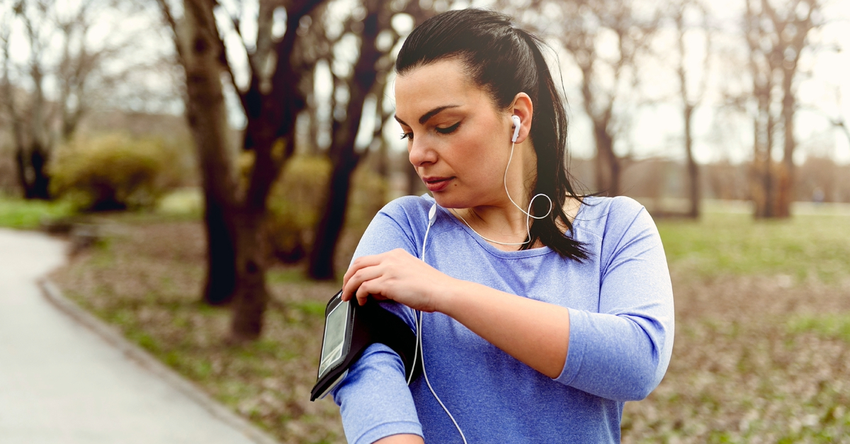 woman exercising and checking her phone