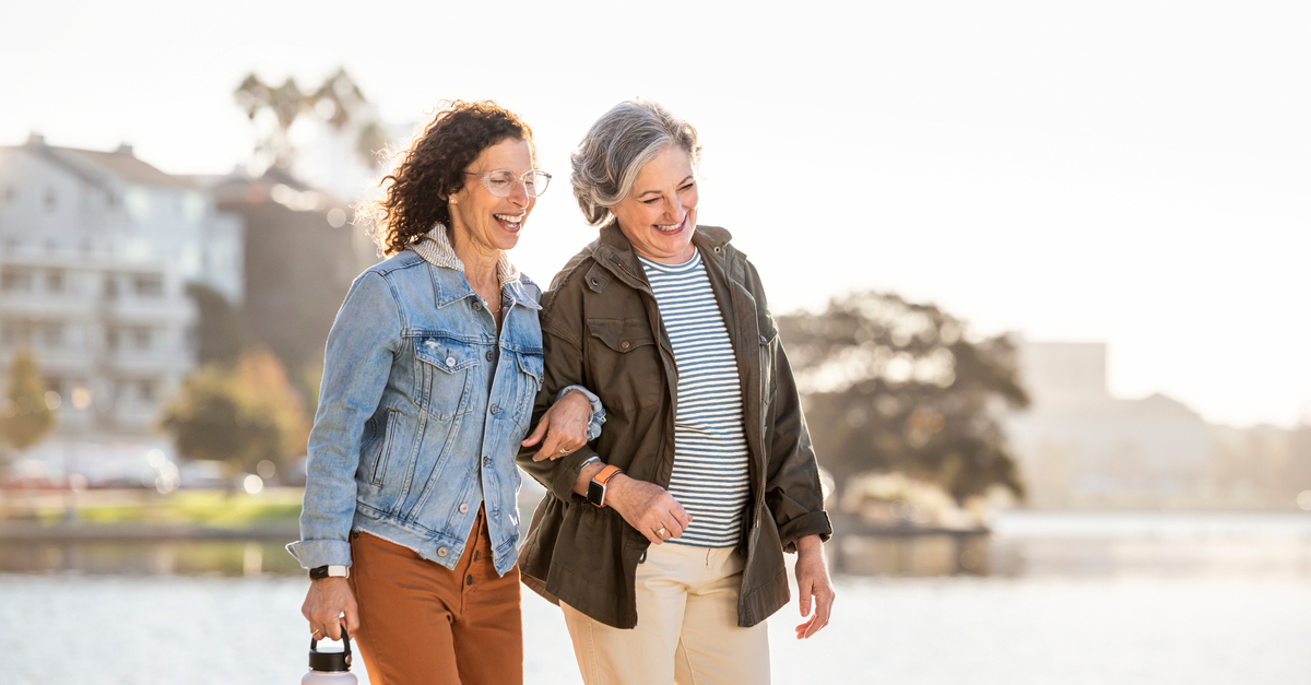 Women walking arm in arm